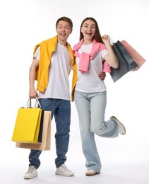 Photo of Happy couple with shopping bags on white background