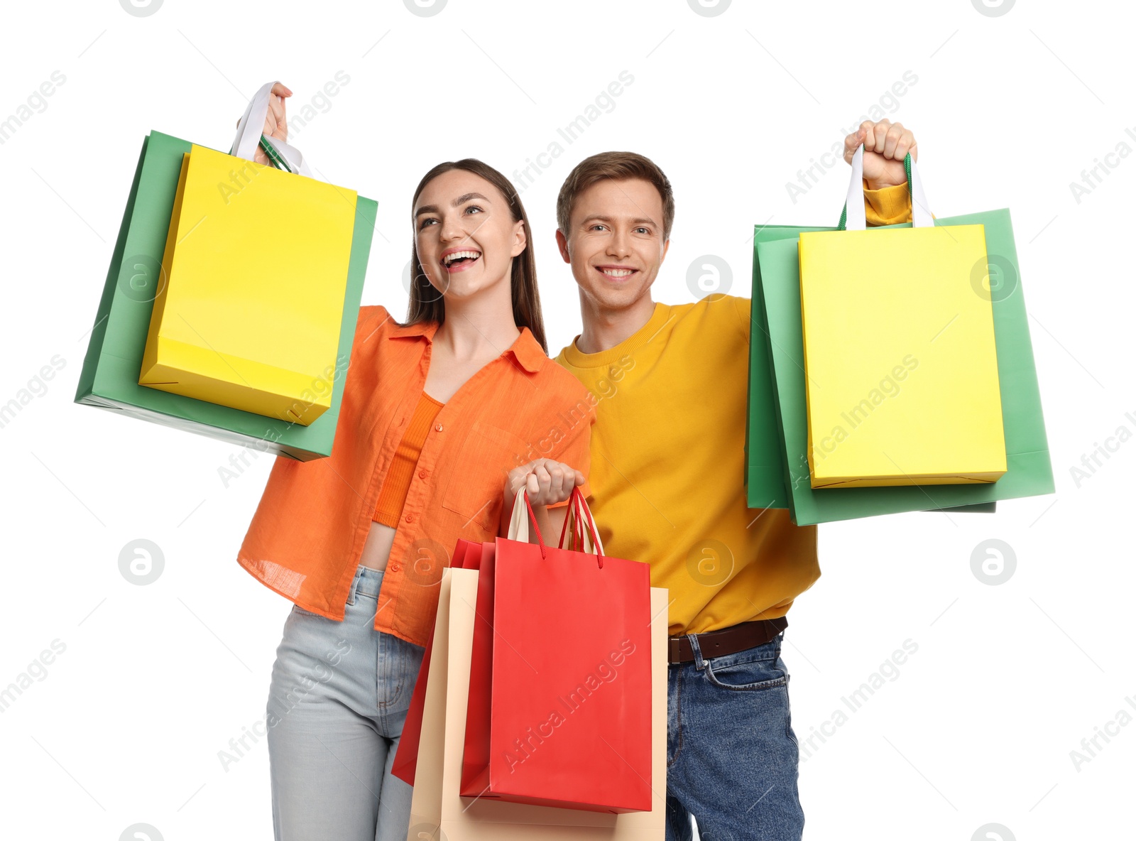 Happy couple with shopping bags on white background Photo of Happy couple with shopping bags on white background