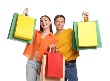 Photo of Happy couple with shopping bags on white background