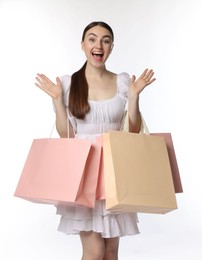 Photo of Excited woman with shopping bags on white background