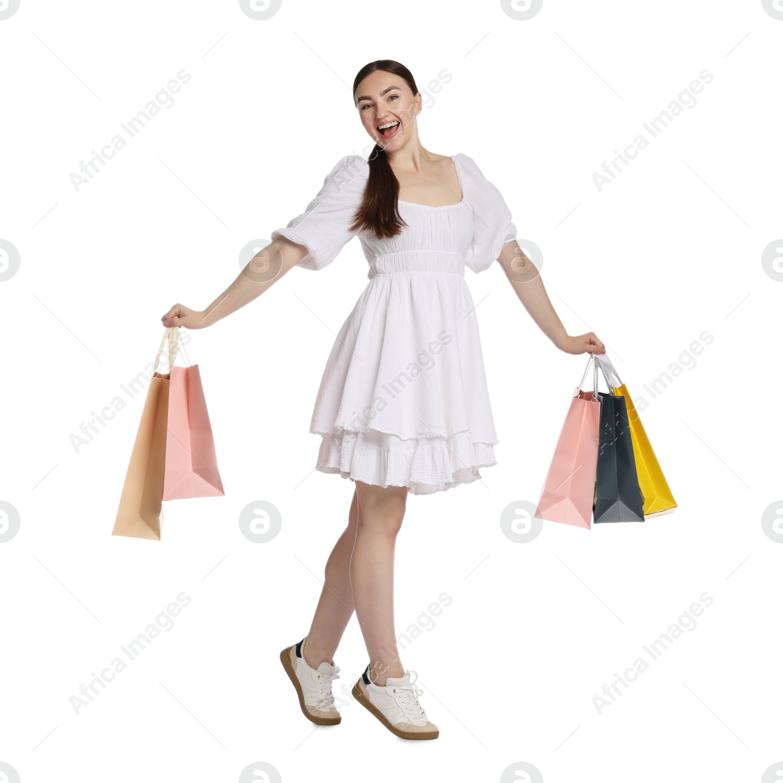 Excited woman with shopping bags on white background Photo of Excited woman with shopping bags on white background