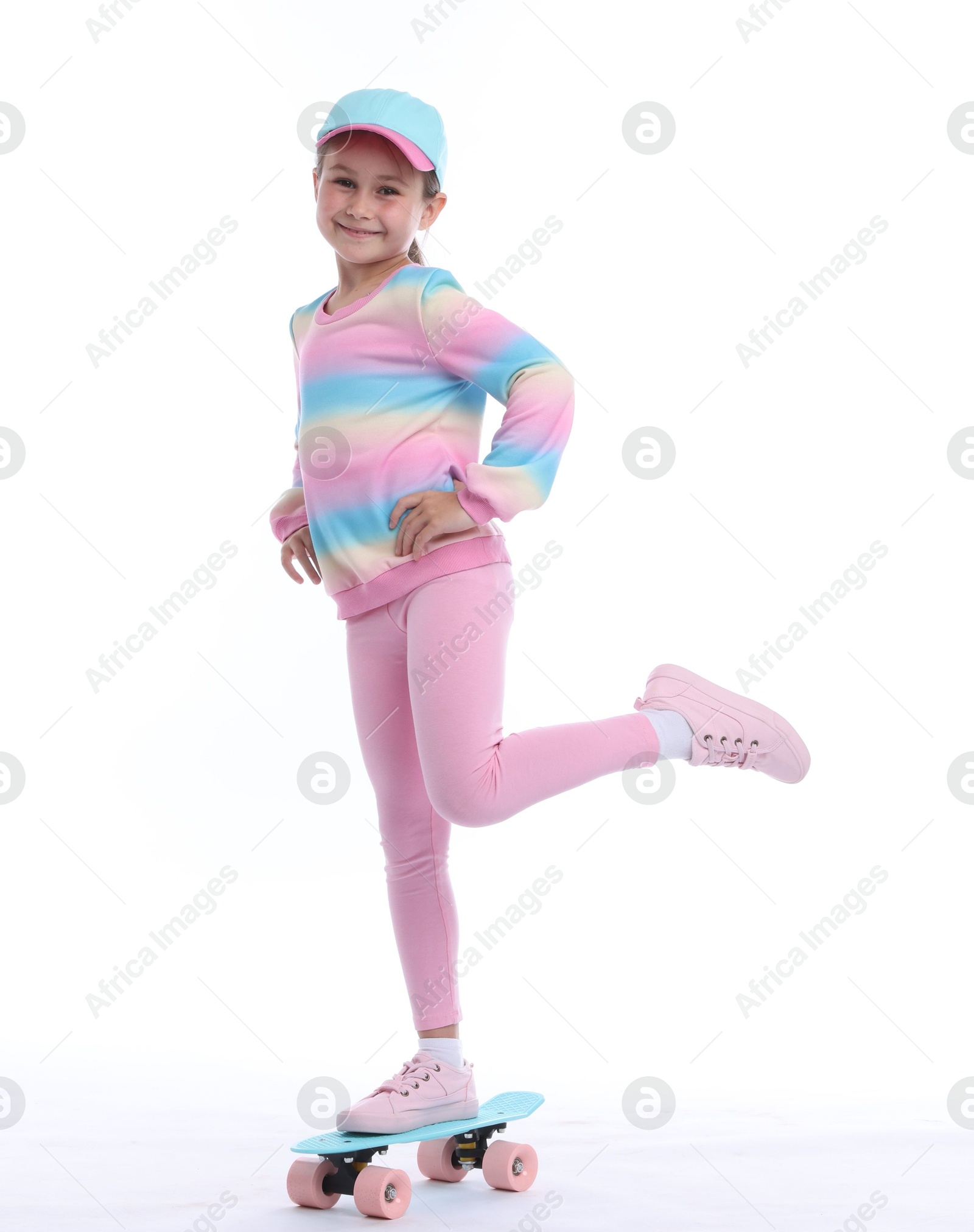 Little girl with penny board on white background Photo of Little girl with penny board on white background