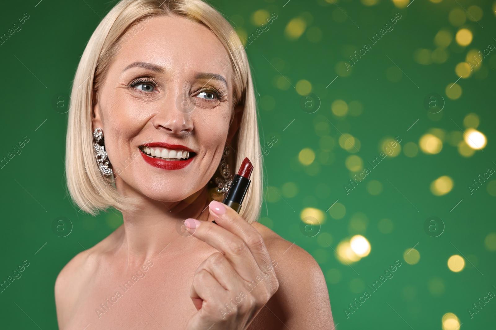 Smiling woman with red lipstick on green background. Bokeh effect Image of Smiling woman with red lipstick on green background. Bokeh effect