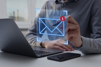 Image of Email marketing, new message notification. Man using virtual screen above laptop at table, closeup