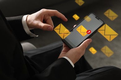 Image of Email marketing, new message notification. Man using mobile phone indoors, closeup. Envelopes around device