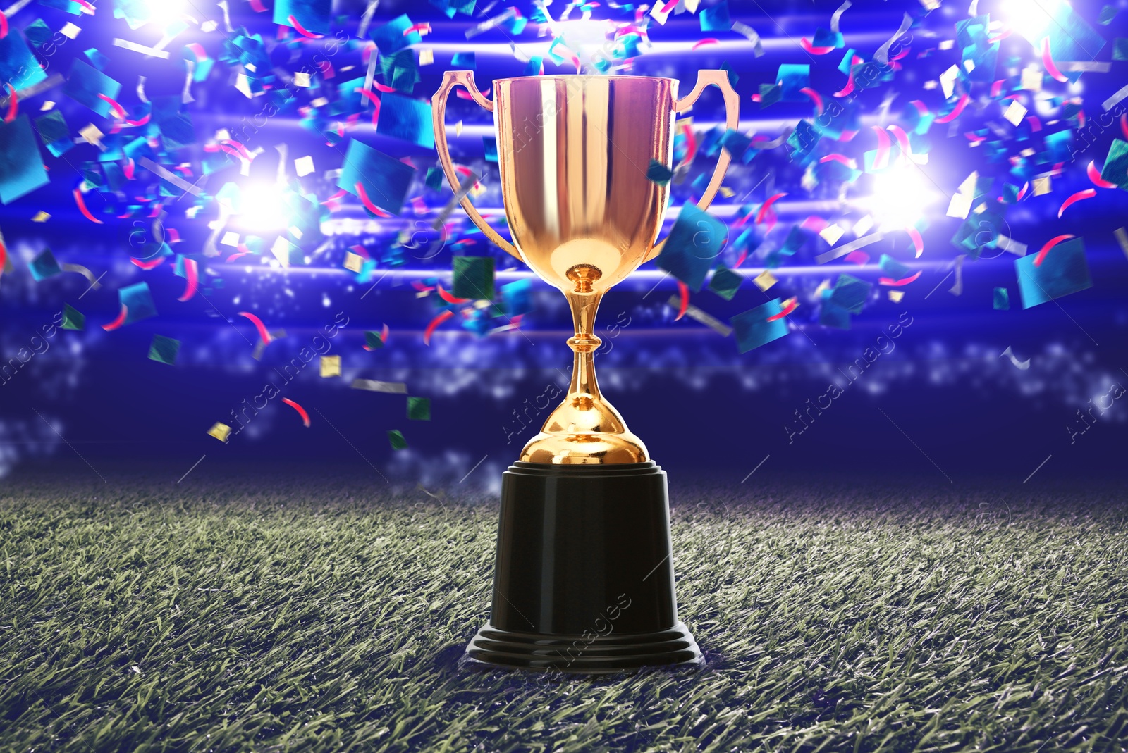 Football championship. Shiny golden trophy cup under falling confetti on illuminated stadium Image of Football championship. Shiny golden trophy cup under falling confetti on illuminated stadium