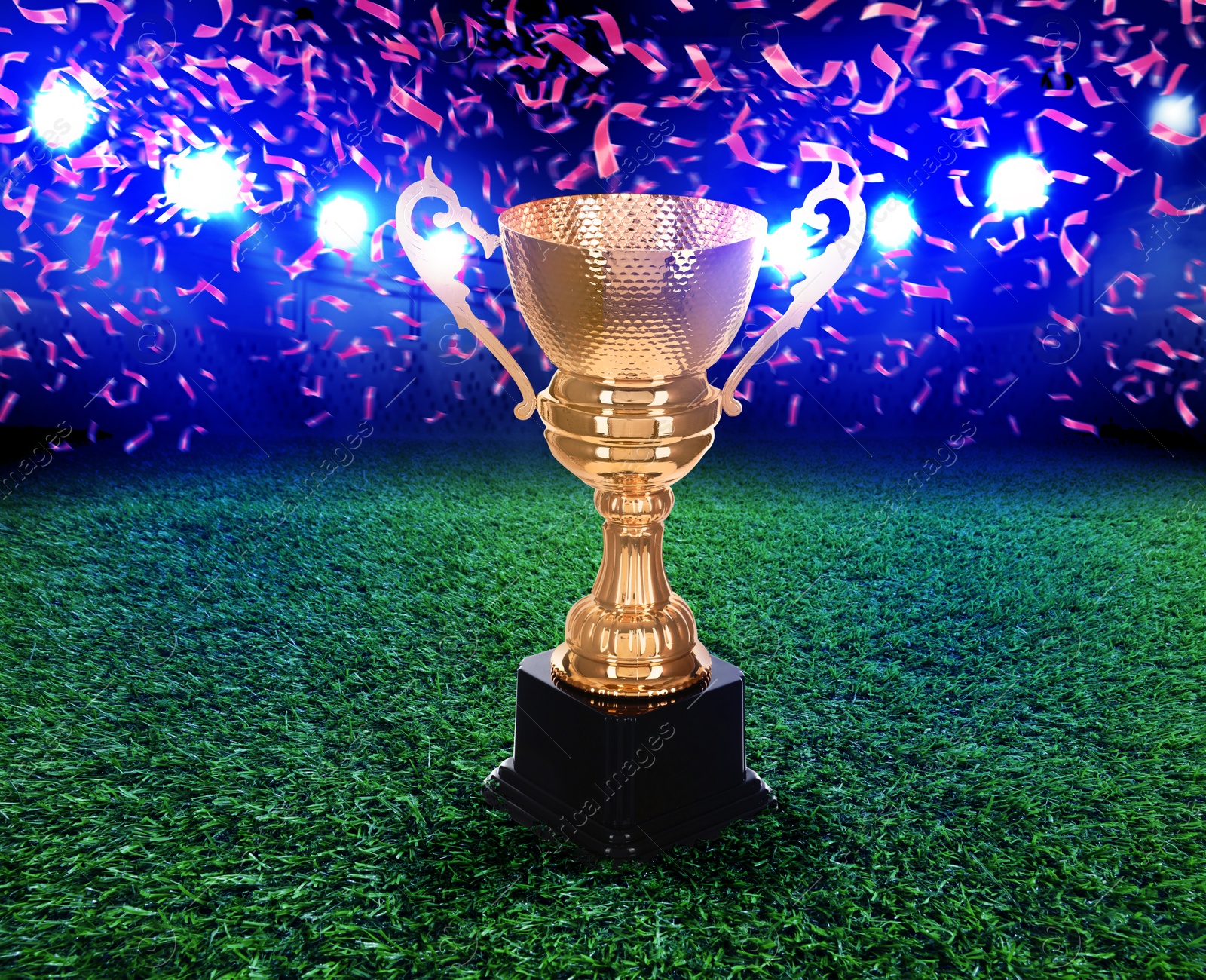 Football championship. Shiny golden trophy cup under falling confetti on illuminated stadium Image of Football championship. Shiny golden trophy cup under falling confetti on illuminated stadium