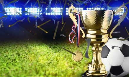 Image of Football championship. Shiny golden trophy cup with medal and soccer ball under falling confetti on stadium, banner design