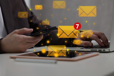 Image of Email marketing, new message notification. Man using laptop and mobile phone at table, closeup
