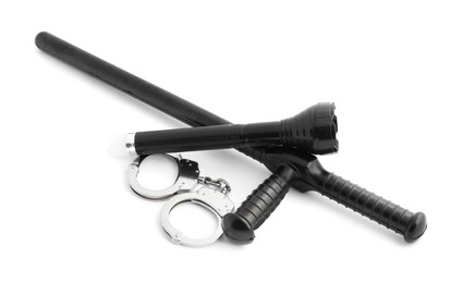 Photo of Police baton, flashlight and handcuffs on white background
