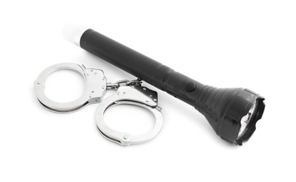 Photo of Flashlight and handcuffs on white background. Police equipment