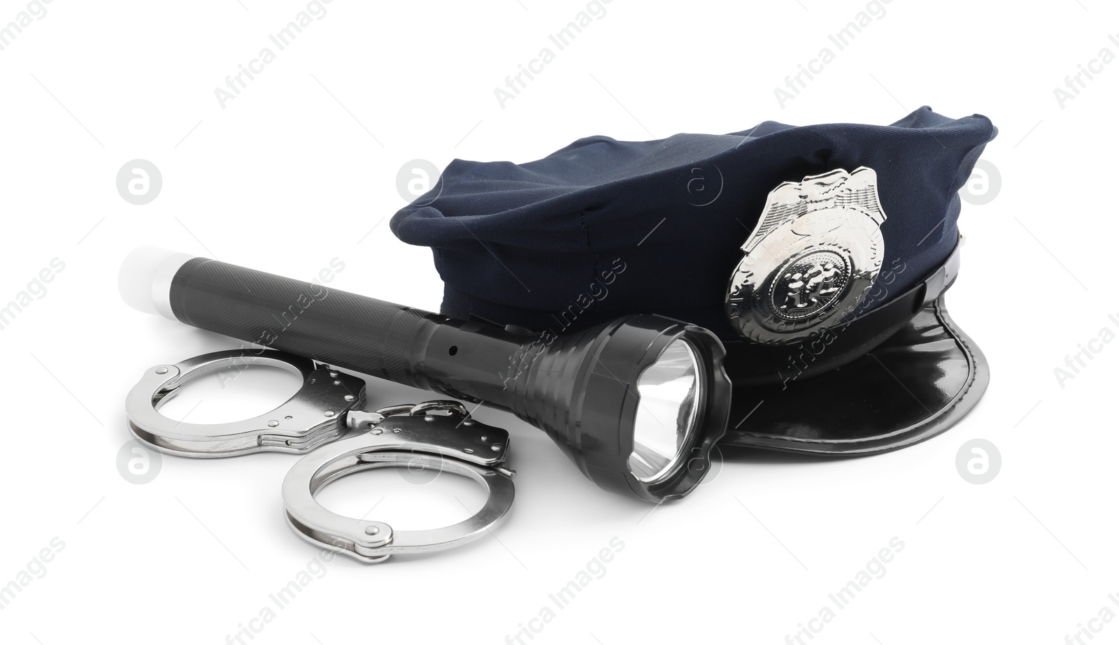 Police cap, flashlight and handcuffs on white background Photo of Police cap, flashlight and handcuffs on white background