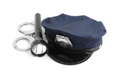 Photo of Police cap, flashlight and handcuffs on white background