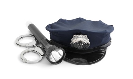 Photo of Police cap, flashlight and handcuffs on white background