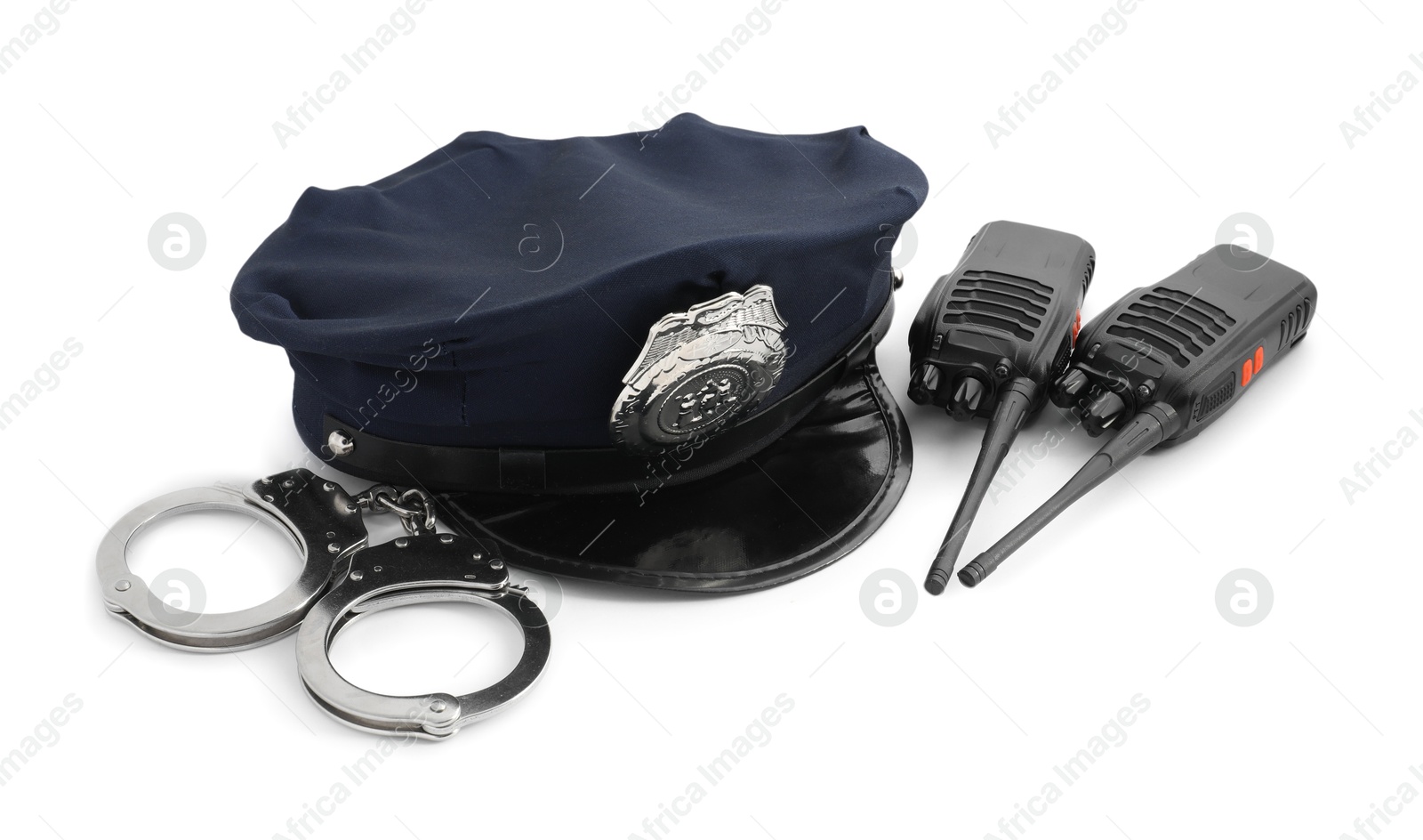 Police cap, walkie talkies and handcuffs on white background Photo of Police cap, walkie talkies and handcuffs on white background