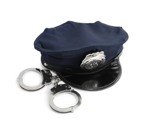 Photo of Police cap and handcuffs on white background