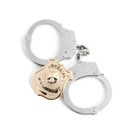 Photo of Police badge and handcuffs on white background, top view