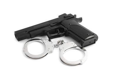 Photo of Gun and handcuffs on white background. Police equipment