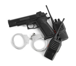 Photo of Gun, handcuffs and walkie talkies on white background, top view. Police equipment