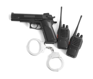 Photo of Gun, handcuffs and walkie talkies on white background, top view. Police equipment