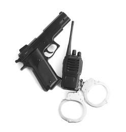 Photo of Gun, handcuffs and walkie talkie on white background, top view. Police equipment
