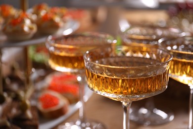 Photo of Buffet menu. Glasses of sparkling wine on table, closeup