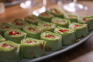 Photo of Buffet menu. Tasty rolls on wooden table, closeup