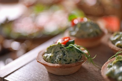 Photo of Buffet menu. Tasty stuffed tartlets on stand, closeup. Space for text