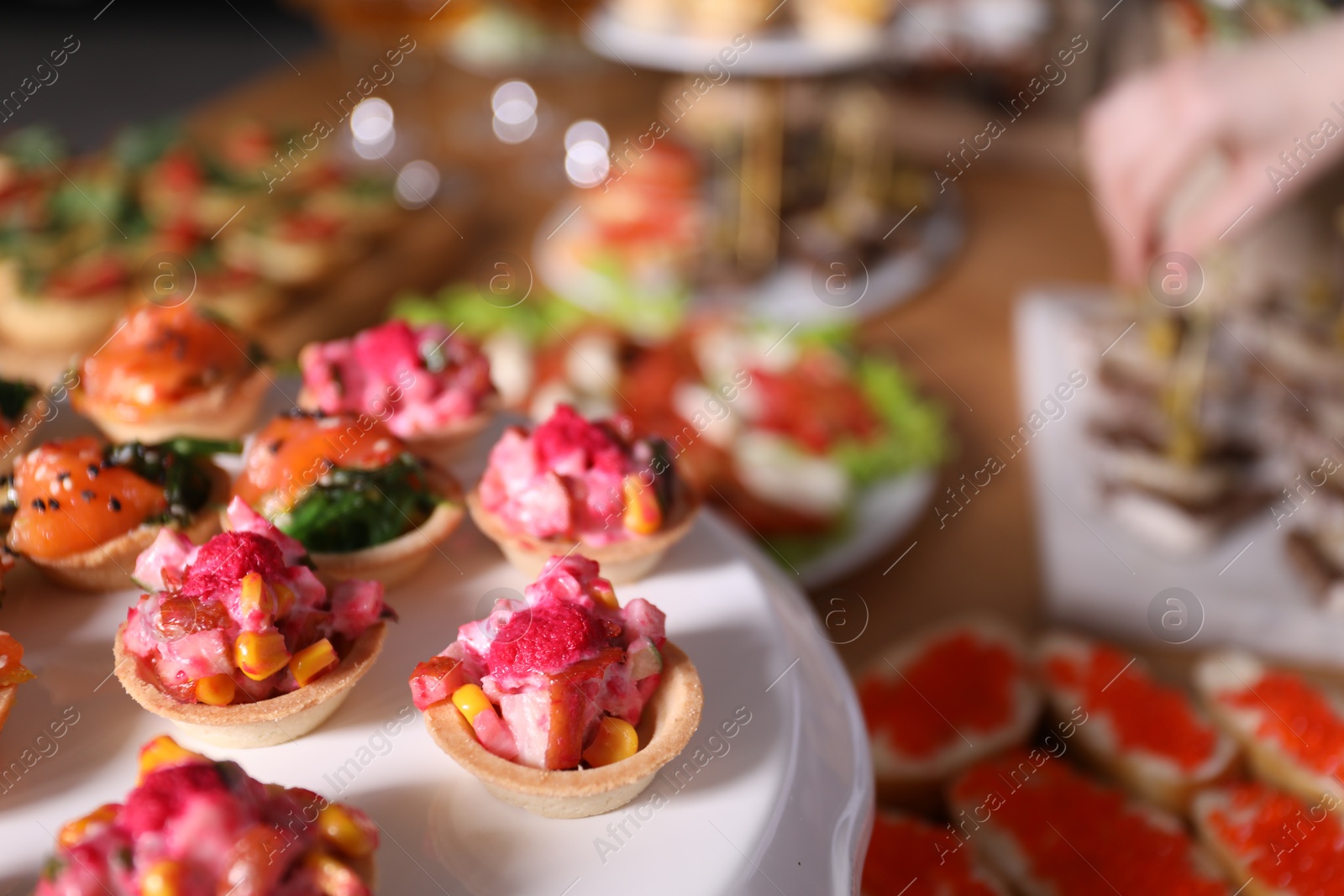 Buffet menu. Tasty stuffed tartlets on stand, closeup Photo of Buffet menu. Tasty stuffed tartlets on stand, closeup
