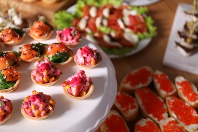 Photo of Buffet menu. Tasty stuffed tartlets on stand, closeup