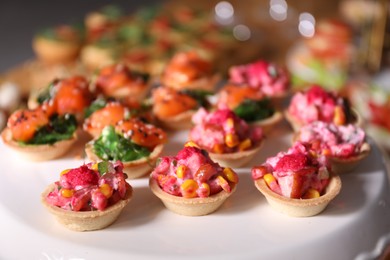 Photo of Buffet menu. Tasty stuffed tartlets on stand, closeup