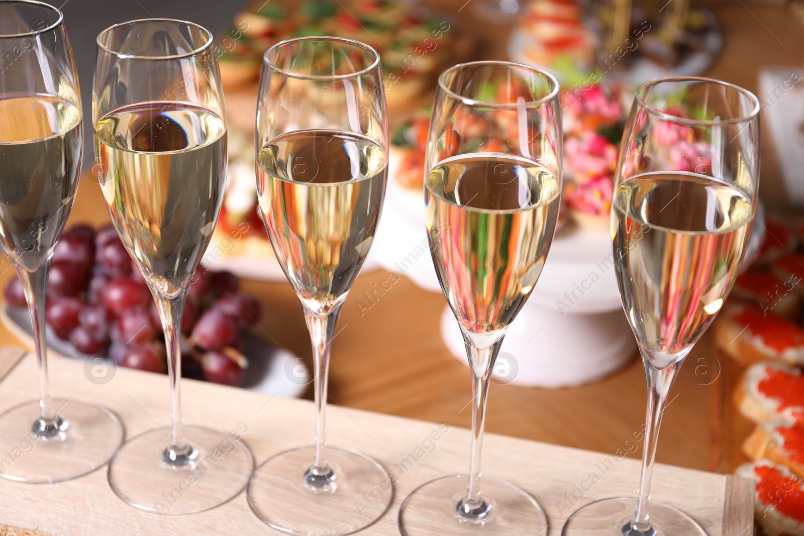 Buffet menu. Glasses of sparkling wine and tasty appetizers on table, closeup Photo of Buffet menu. Glasses of sparkling wine and tasty appetizers on table, closeup