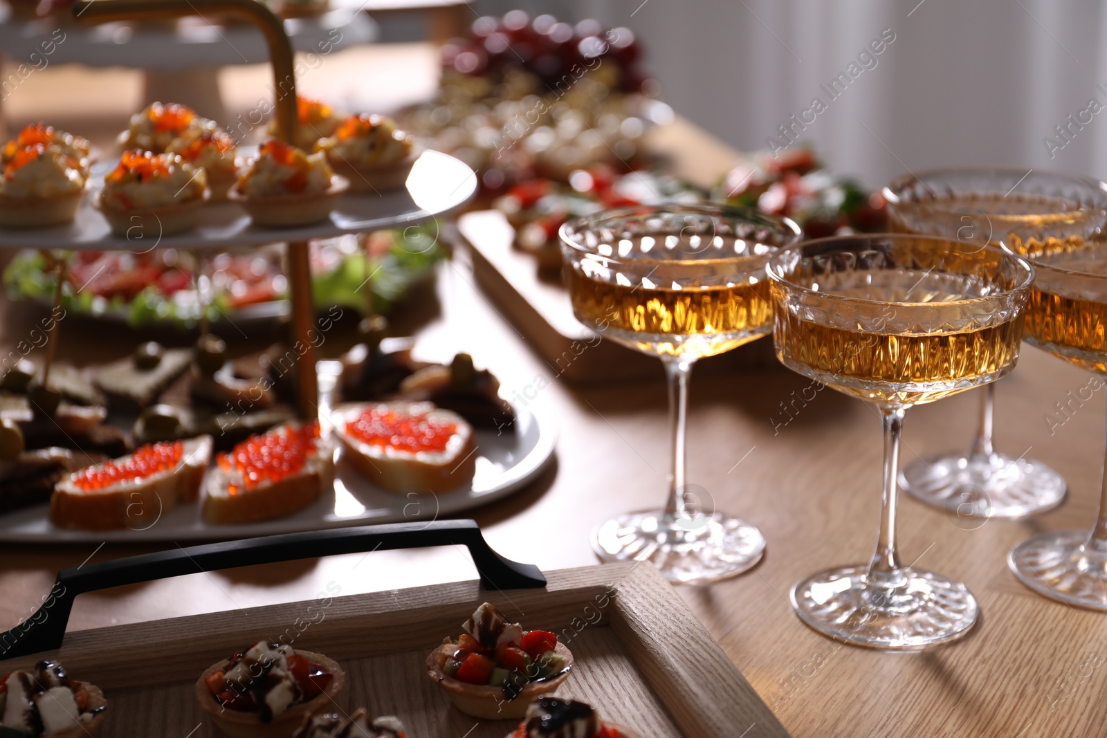 Buffet menu. Glasses of sparkling wine and tasty appetizers on table, closeup Photo of Buffet menu. Glasses of sparkling wine and tasty appetizers on table, closeup