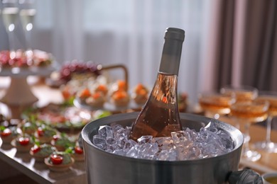 Photo of Buffet menu. Bottle of sparkling wine on table, closeup