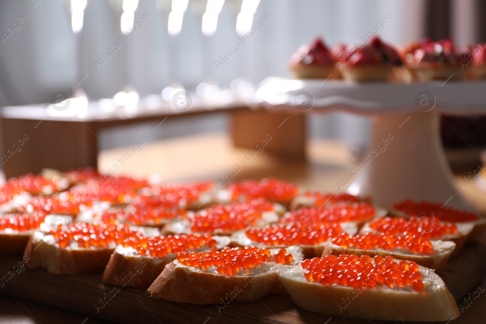 Buffet menu. Tasty sandwiches with red caviar on table, closeup Photo of Buffet menu. Tasty sandwiches with red caviar on table, closeup