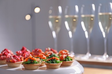 Photo of Buffet menu. Tasty stuffed tartlets on stand, closeup