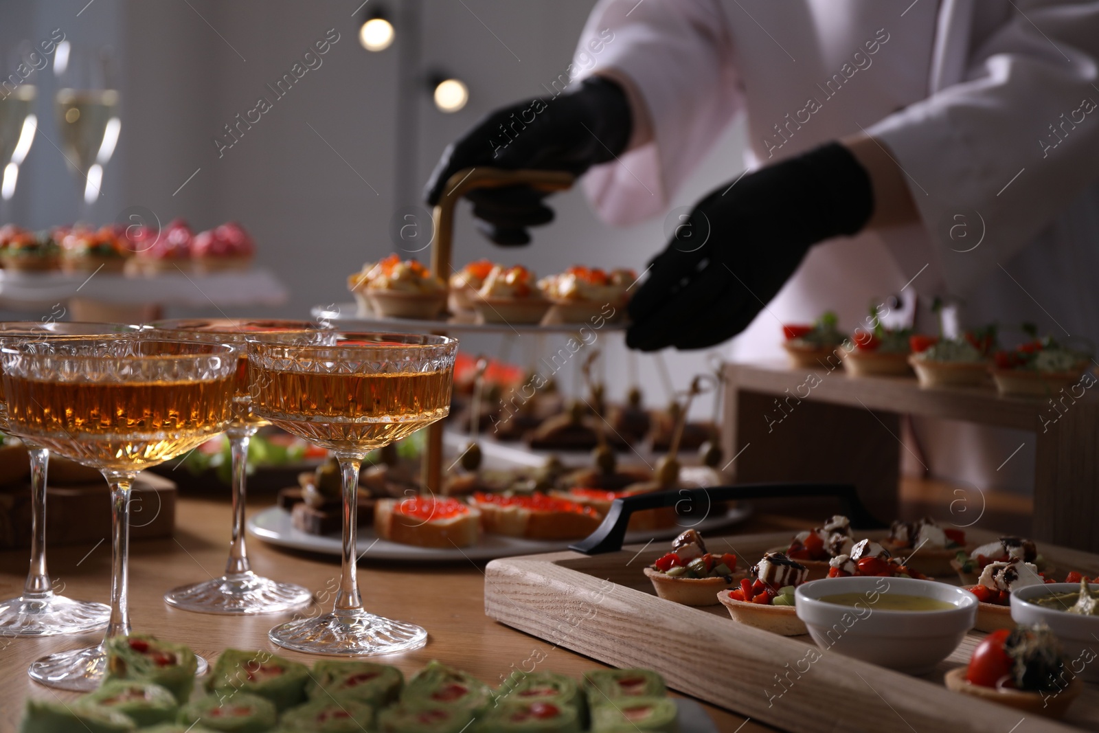 Chef arranging appetizers on buffet table, selective focus Photo of Chef arranging appetizers on buffet table, selective focus