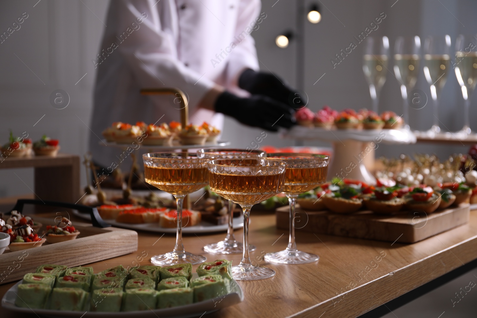 Chef arranging appetizers on buffet table, selective focus Photo of Chef arranging appetizers on buffet table, selective focus