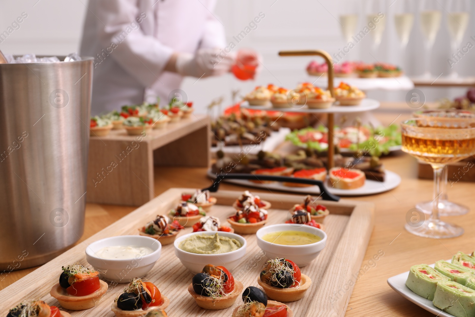 Chef arranging appetizers on buffet table, selective focus Photo of Chef arranging appetizers on buffet table, selective focus