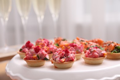 Photo of Buffet menu. Tasty stuffed tartlets on stand, closeup. Space for text