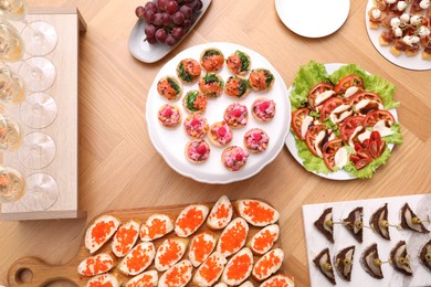 Photo of Buffet menu. Many different appetizers on wooden table, flat lay