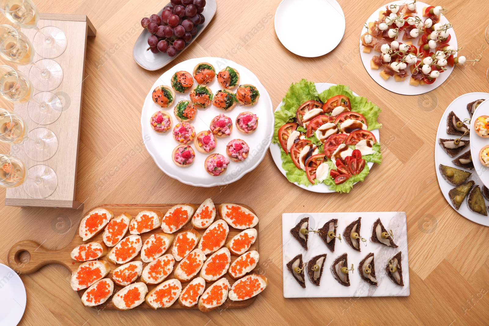 Buffet menu. Many different appetizers on wooden table, flat lay Photo of Buffet menu. Many different appetizers on wooden table, flat lay