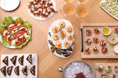 Photo of Buffet menu. Many different appetizers on wooden table, flat lay