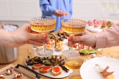 Photo of Buffet menu. Women toasting at table, closeup