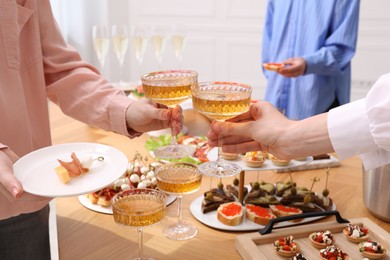 Photo of Buffet menu. Women toasting at table, closeup