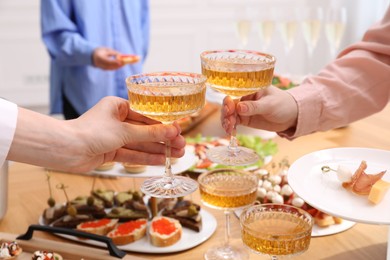 Photo of Buffet menu. Women toasting at table, closeup