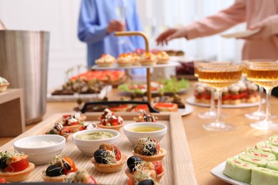 Photo of People with different appetizers at buffet, selective focus