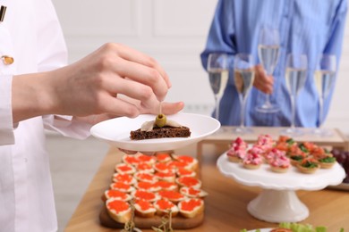 Photo of People with different appetizers at buffet, closeup