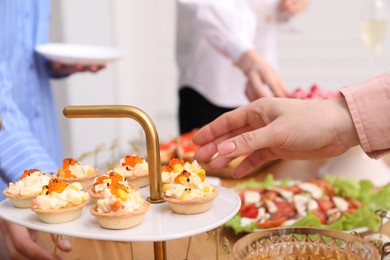 Photo of People with different appetizers at buffet, selective focus