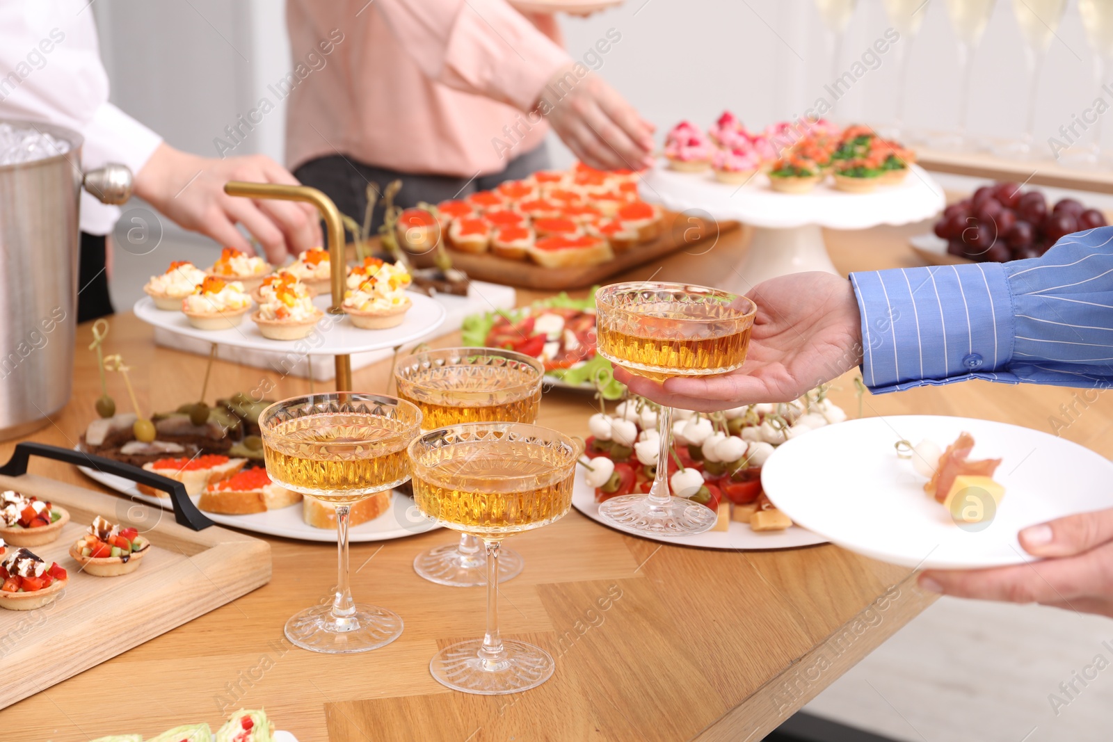 People with different appetizers at buffet, closeup Photo of People with different appetizers at buffet, closeup
